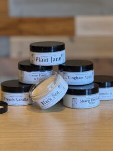 jars of body butter stacked on a table