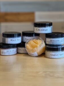 jars of sugar scrub stacked on a table