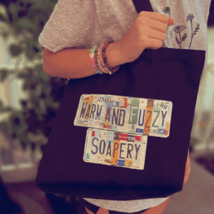 black canvas bag with warm and fuzzy soapery ogo