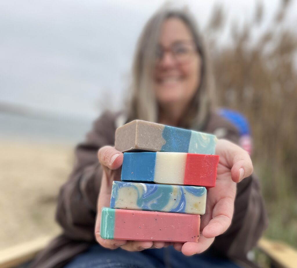 Margaret Connor, owner, holding summer soaps