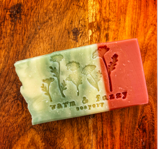 a bar of soap green and white on one side and red on the other