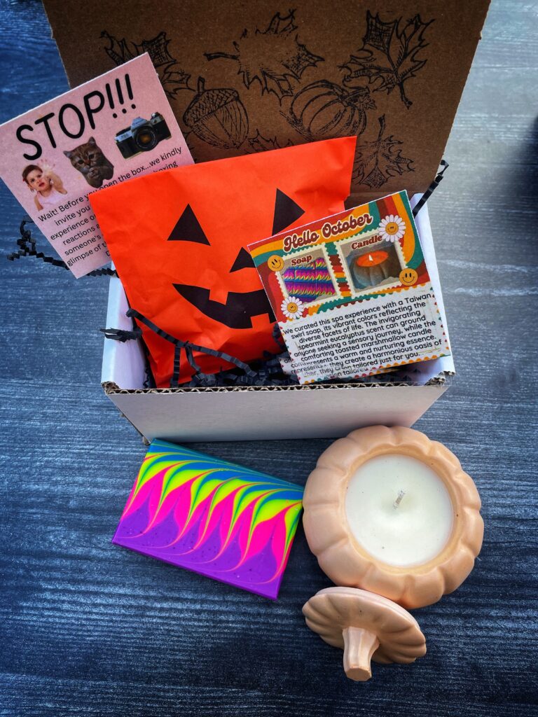 a box with a jacolantern bag, information cards, and a colorful bar of soap with a concrete pumpkin