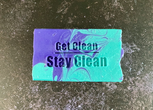 purple and teal soap stamped with the words "get clean stay clean"